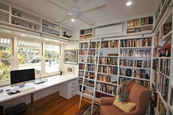 home office library with desk and library ladder